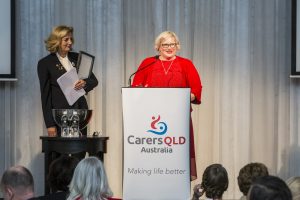 Kylie Minns making a speech at the podium after winning the "Why do I care?" writing competition at the 2018 Gala Lunch